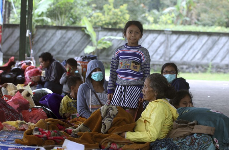 Villagers rest at an evacuee camp in Rendang, Bali, Indonesia, Monday, Sept. 25, 2017. More than 35,000 people have fled a menacing volcano on the Indonesia tourist island of Bali, fearing will erupt for the first time in more than half a century as increasing tremors rattle the region. (AP Photo/Firdia Lisnawati) 