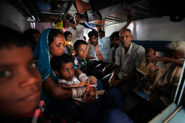New Delhi train passengers sit stranded in a darkened train idled by the massive power outage that swept across India on Tuesday.